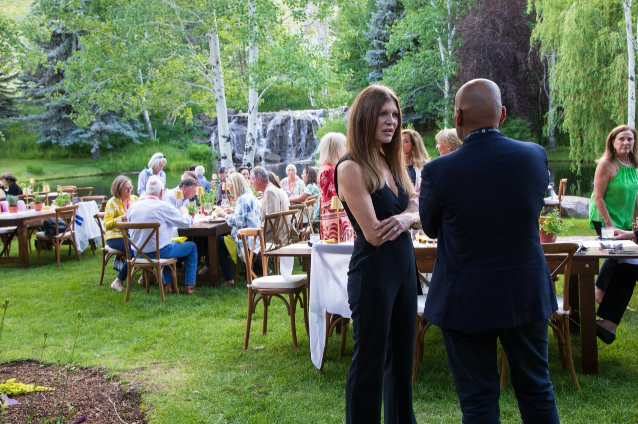 An outdoor dinner beside the waterfall at the 2025 Summer Institute